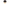 Small figurine with a black hat and purple dot on a white background